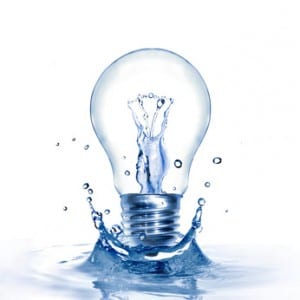 Energy concept. Light bulb with water and splash isolated on white